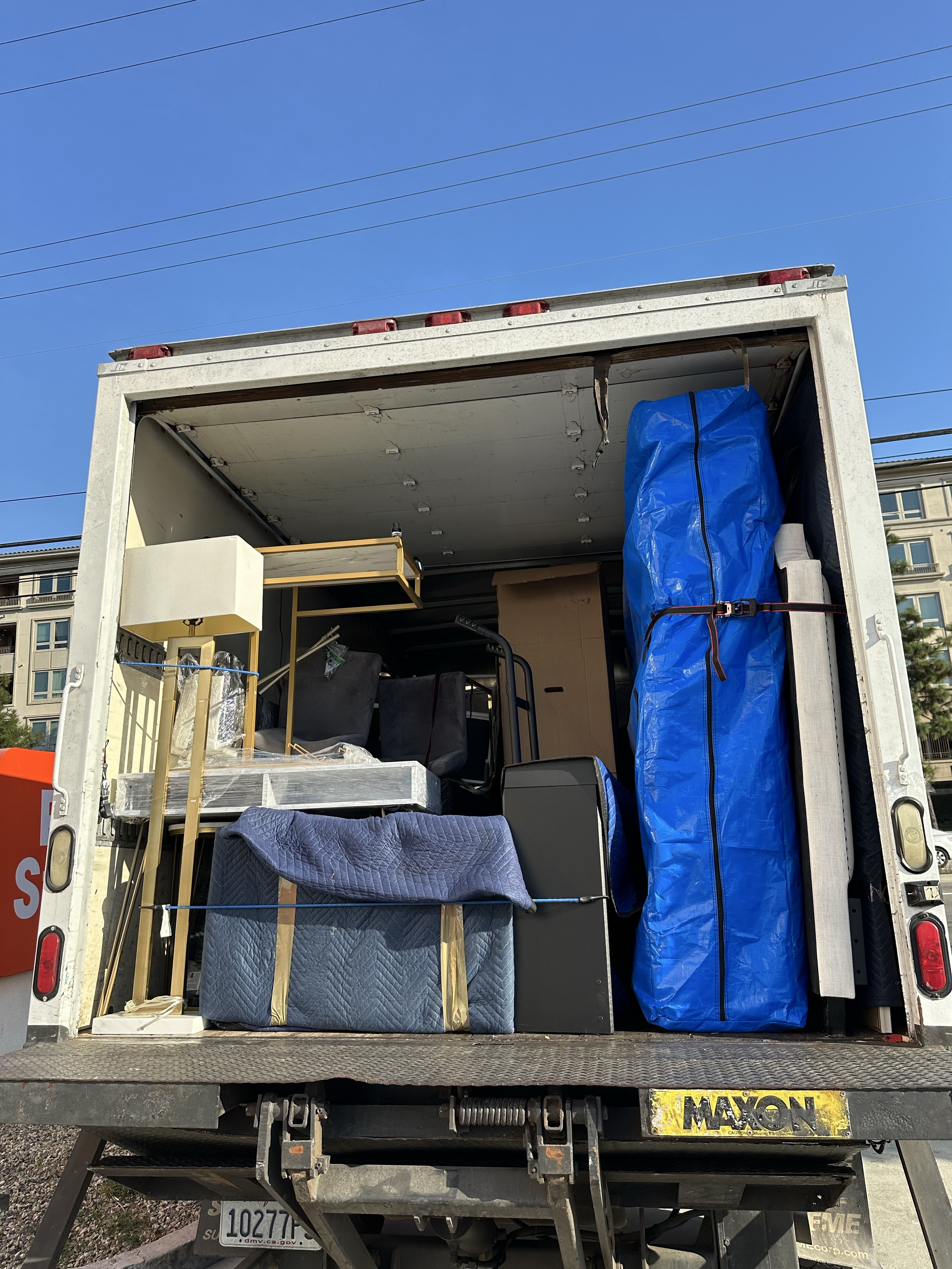 Moving truck loaded with wrapped furniture and secured items